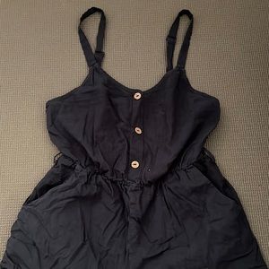 Navy blue romper with adjustable straps.